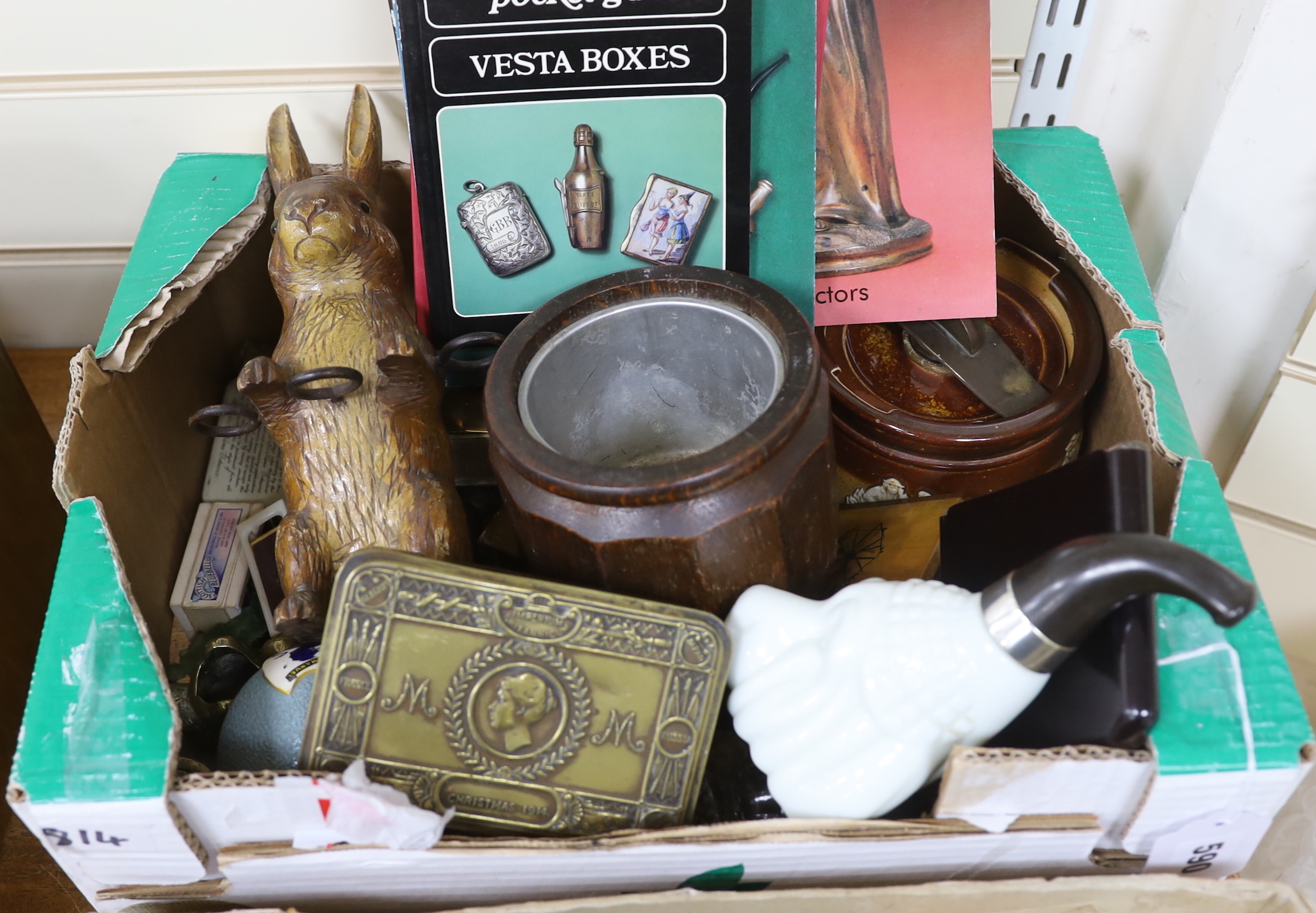 A collection of Vesta boxes, matchbox holders and other related ephemera, mostly metal examples, some with enamel panels, candle holders, wooden boxes, together with a rabbit pipe rack, tobacco jars, cigarette cases, etc